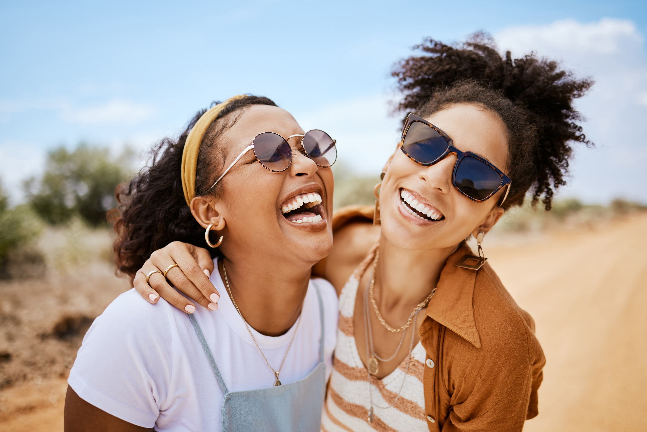 Two smiling girls outside